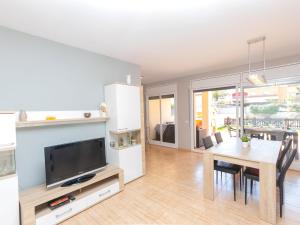 a living room with a dining room table and a tv at Holiday Home Nova by Interhome in Segur de Calafell