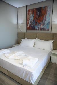 Letto o letti in una camera di Hotel Qeparo