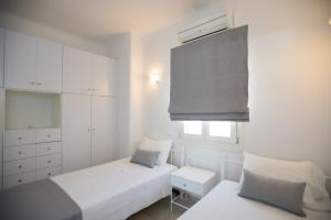 Postel nebo postele na pokoji v ubytování Villa Nireas