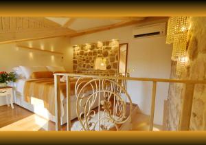 a bedroom with a bed and a stone wall at Villa Madonna della Strada A5 in Dubrovnik