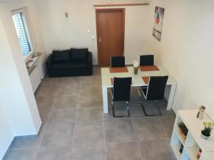 a living room with a table and chairs and a couch at Ferienwohnung am Wiedenberg in Arnsberg