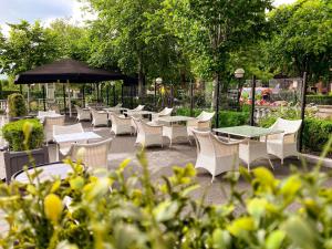 a patio area with tables, chairs and umbrellas at Hampton Hotel in Dublin