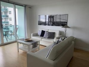 a living room with a couch and a table at Apartamento en la Playa The Tides in Hollywood