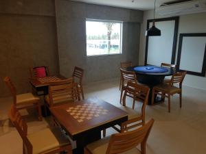 a dining room with tables and chairs and a window at Salinas Park Rersort in Salinópolis +4 photos