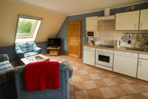 a kitchen with two chairs and a table in a room at Sina in Pruchten