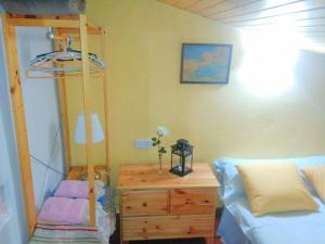 a bedroom with a bunk bed and a dresser with a desk at Casa Valentina in Salvacañete