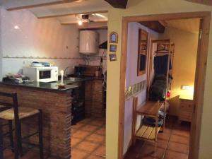 a small kitchen with a counter and a microwave at Casa Valentina in Salvacañete