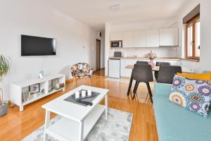 a living room with a couch and a table at Apartman Libra Zlatibor in Zlatibor