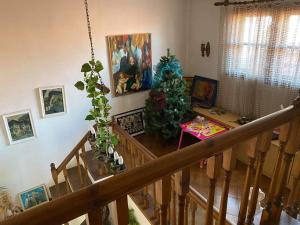 a room with a staircase with paintings and a christmas tree at Art Studio in Sapareva Banya