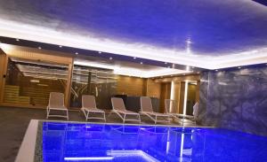 a conference room with chairs and a swimming pool at Brilliant Hotel & SPA in Golem