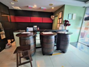 a bar with two wine barrels in a restaurant at Bee Garden & BB Motel - Alor Setar in Alor Setar