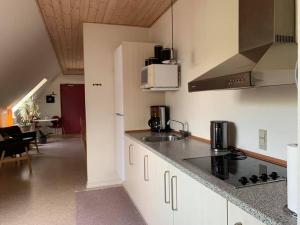 a kitchen with a sink and a counter top at Dortes Bed & Breakfast in Lintrup