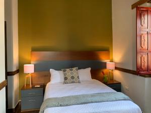 a bedroom with a large bed with two lamps at Casa Hidalgo in Ciudad Hidalgo