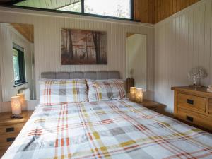 a bedroom with a bed and a window and lights at Pine Tree in Newcastle upon Tyne