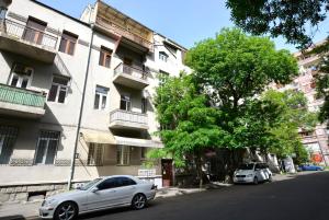 two cars parked in front of a building at Jasmin apt with balcony at Republic Square & Ruben tours in Yerevan