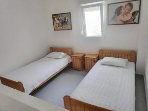 a room with two beds and a window at Maisonette with Garden& Parking Polichrono in Polychrono