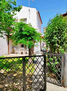 a gate with a table and chairs in a yard at Maisonette with Garden& Parking Polichrono in Polychrono +9 photos