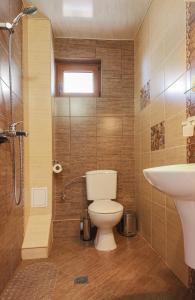 a bathroom with a toilet and a sink at Guesthouse Phoenix in Obzor