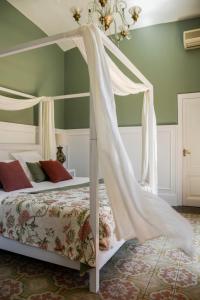 a bedroom with a bed with a canopy at Hotel Aiguaclara in Begur