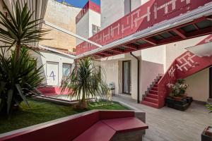 a building with a red couch in a courtyard at Hospitality Hotel in Palermo