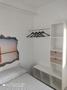 a white room with a bed and a stove at La Burbuja in Almería