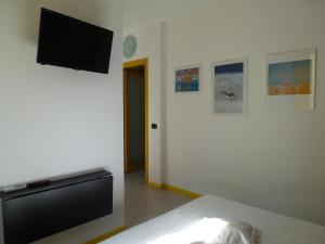 Schlafzimmer mit einem Bett und einem Flachbild-TV in der Unterkunft ibagnanti in Porto Recanati