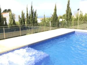 a swimming pool on the roof of a house at Villa Orquidea in Son Bou