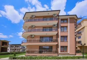 an apartment building with balconies on the side at Guesthouse Phoenix in Obzor +25 photos