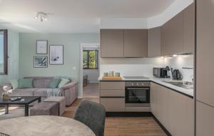 a kitchen and living room with a couch and a table at JUST RENOVATED stylish 2 bedrooms apartment only a few steps from the beach! in Novigrad Istria