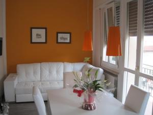 a living room with a white couch and a table at Bed and Breakfast lo Scrigno in Polinago