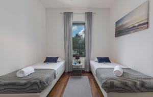 two beds in a room with a window at SPADA Apartment 3 bedrooms near the beach! in Poreč