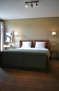 a bedroom with a large bed with two pillows at Maison du chien vert in Corbion