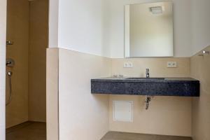 a bathroom with a sink and a shower at Villa Zeitlos in Börgerende-Rethwisch