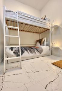 two bunk beds in a room with a marble floor at In Den Visser in Dordrecht