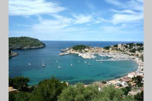 a view of a harbor with boats in the water at Apartamento en el Puerto de Sóller con gran terraza privada y vistas al mar. Piscina comunitaria. Localizado en un zona tranquila y muy soleada. Wifi gratis disponible. Parking. in Port de Soller +8 photos