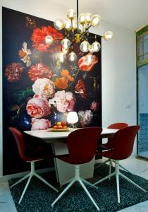 a dining room table with chairs and a chandelier at In Den Visser in Dordrecht