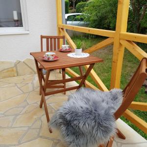 a dog sitting on a chair next to a table at Ferienhaus Alexandra in Böllenborn