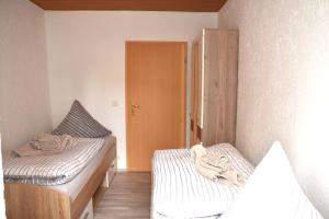 a small room with two beds and a closet at FeWo 1 - Deidesheim in Deidesheim