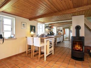 a kitchen with a wood stove in a room at Holiday home Rudkøbing XI in Rudkøbing