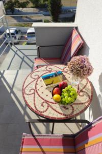 a table with a plate of fruit on a balcony at Pavle's Apartment in Zadar