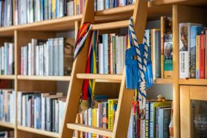 a book shelf filled with lots of books at Fred&Breakfast in Ghent