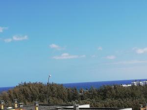 a view of a city with trees and a blue sky at Calm Rest in Costa Calma