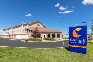 a building with a sign in front of it at Comfort Inn & Suites Near University of Wyoming in Laramie