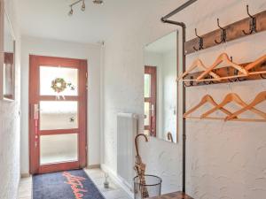 a room with a red door and a mirror at Sunny flat in Bad Driburg with garden in Bad Driburg