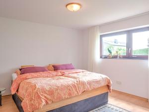 a bedroom with a bed and a window at Sunny flat in Bad Driburg with garden in Bad Driburg