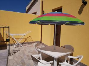 a table and chairs and an umbrella on a patio at Appartamento a San Vito lo capo in San Vito lo Capo