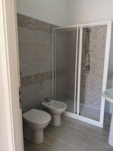 a bathroom with a toilet and a sink and a shower at Appartamento a San Vito lo capo in San Vito lo Capo +9 photos