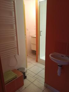 a small bathroom with a sink and a mirror at Figalrance Studio in Plouër-sur-Rance