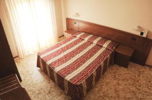 Postel nebo postele na pokoji v ubytování HOTEL IL CORALLO