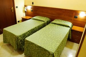 Postel nebo postele na pokoji v ubytování HOTEL IL CORALLO